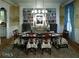 Elegant dining room featuring a large dining table with decorative chairs and a large bookcase at 315 Westbourne Dr, Tyrone, GA 30290