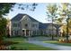 Stunning stone home with a circular drive and lush front lawn and manicured landscaping at 315 Westbourne Dr, Tyrone, GA 30290