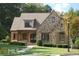 Stone-clad home with manicured lawn, landscaped shrubs, and inviting entryway at 315 Westbourne Dr, Tyrone, GA 30290