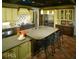 Spacious kitchen featuring a large island with seating, a stainless steel refrigerator, and terracotta flooring at 315 Westbourne Dr, Tyrone, GA 30290