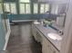 A bright bathroom with double sinks, a vanity, and several windows that provide lots of natural light at 205 Aberdeen Dr, Peachtree City, GA 30269