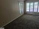 Bedroom featuring neutral walls, multiple windows providing natural light, and wall-to-wall carpeting at 205 Aberdeen Dr, Peachtree City, GA 30269