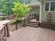 Spacious wooden deck with stairs and beautiful landscaping, perfect for outdoor entertaining and relaxation at 205 Aberdeen Dr, Peachtree City, GA 30269
