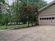 Charming home exterior showcasing a well-maintained garage and lush green surroundings at 205 Aberdeen Dr, Peachtree City, GA 30269
