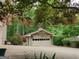 View of the single-car garage, including a beautiful maple tree at 205 Aberdeen Dr, Peachtree City, GA 30269