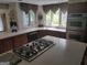 Bright kitchen featuring an island cooktop, built-in double oven, ample counter space and generous natural light at 205 Aberdeen Dr, Peachtree City, GA 30269