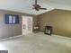 Open living room with carpet, featuring a TV and French doors leading to another room at 205 Aberdeen Dr, Peachtree City, GA 30269