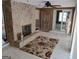 Inviting living room features a stone fireplace, neutral tile flooring, and access to the outdoors at 205 Aberdeen Dr, Peachtree City, GA 30269