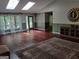 Bright living room featuring hardwood floors, a stone fireplace and natural lighting from skylights and windows at 205 Aberdeen Dr, Peachtree City, GA 30269