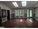 Well lit living room with hardwood floors, large windows, skylights and green accents at 205 Aberdeen Dr, Peachtree City, GA 30269