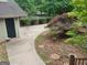 View of the side yard featuring a garden area and a single-car garage at 205 Aberdeen Dr, Peachtree City, GA 30269