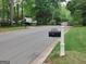 Quiet street view with mailboxes and houses in a residential neighborhood at 205 Aberdeen Dr, Peachtree City, GA 30269