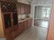 Stylish wet bar with dark wood cabinets, wine rack, and views of the living room at 205 Aberdeen Dr, Peachtree City, GA 30269