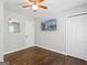 Bright bedroom with hardwood floors, ceiling fan, and mounted TV at 1599 Ezra Church Nw Dr, Atlanta, GA 30314