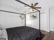 Bedroom with dark, four poster bed, hardwood floors, and mounted TV at 1599 Ezra Church Nw Dr, Atlanta, GA 30314
