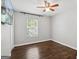 Cozy bedroom featuring a ceiling fan, window and hardwood flooring at 1599 Ezra Church Nw Dr, Atlanta, GA 30314