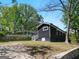 Side view of a modern home with dark siding, green lawn, and mature trees at 1599 Ezra Church Nw Dr, Atlanta, GA 30314