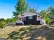 A charming house with a black brick exterior and white trim is seen from a low-angle side view at 1599 Ezra Church Nw Dr, Atlanta, GA 30314