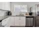 Bright kitchen with white cabinetry, stainless steel appliances, granite countertops, and modern fixtures at 1599 Ezra Church Nw Dr, Atlanta, GA 30314
