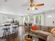 Open concept living room, features hardwood floors, kitchen bar, and a comfortable seating area at 1599 Ezra Church Nw Dr, Atlanta, GA 30314