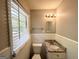 Cozy bathroom featuring white tile, granite countertop vanity, and window with natural light at 1417 Lavender Nw Dr, Atlanta, GA 30314