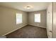 Bedroom with neutral walls, plush carpet and natural light from two windows at 1417 Lavender Nw Dr, Atlanta, GA 30314