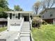 Charming home with brick and lush landscaping with a stairway leading up to the covered entry at 1417 Lavender Nw Dr, Atlanta, GA 30314