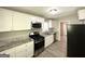 Modern kitchen featuring stainless steel appliances, granite counters, and white cabinets at 1417 Lavender Nw Dr, Atlanta, GA 30314