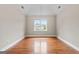 A bedroom features hardwood floors, a vaulted ceiling, and a window view of the exterior at 212 Birkhill, Peachtree City, GA 30269