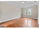 An empty bedroom with hardwood floors, neutral walls, and a ceiling fan fixture at 212 Birkhill, Peachtree City, GA 30269