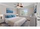 Bright bedroom boasts a ceiling fan, large window with natural light, and elegant, neutral decor at 212 Birkhill, Peachtree City, GA 30269