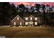 Two story brick home with mature trees, lush lawn, and inviting front porch at 212 Birkhill, Peachtree City, GA 30269