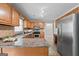 Functional kitchen equipped with wood cabinets, stainless steel appliances, and tiled flooring at 212 Birkhill, Peachtree City, GA 30269