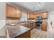 Well-lit kitchen features stainless steel appliances, tile backsplash, and ample counter space at 212 Birkhill, Peachtree City, GA 30269