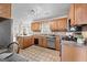 Cozy kitchen featuring wood cabinets, stainless steel appliances, and a breakfast nook at 212 Birkhill, Peachtree City, GA 30269
