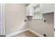 Practical laundry room with tile floors and storage cabinets at 212 Birkhill, Peachtree City, GA 30269