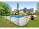 Backyard pool with diving board and lush landscaping, perfect for summer relaxation and entertaining at 212 Birkhill, Peachtree City, GA 30269