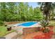 Private backyard pool surrounded by lush greenery offers a relaxing outdoor oasis at 212 Birkhill, Peachtree City, GA 30269