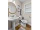 Neat powder room features pedestal sink, tile floor, and window at 212 Birkhill, Peachtree City, GA 30269