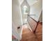 Staircase with hardwood steps and white railing leading to the front door at 212 Birkhill, Peachtree City, GA 30269