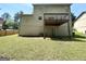 Backyard with a lawn area and a deck with a door leading to the basement at 2717 Knollberry Ln, Decatur, GA 30034