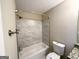 Bathroom featuring a tub with tiled walls, a toilet, and granite countertops at 2717 Knollberry Ln, Decatur, GA 30034