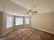 Spacious bedroom with plush carpeting, neutral walls, and abundant natural light from multiple windows at 2717 Knollberry Ln, Decatur, GA 30034