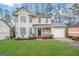 Charming two-story home with well-manicured lawn and cozy front porch with stone accents at 2717 Knollberry Ln, Decatur, GA 30034