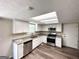 Modern kitchen with white cabinets, stainless steel appliances, and ample counter space at 2717 Knollberry Ln, Decatur, GA 30034