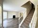 Spacious living room featuring wood floors, a fireplace and staircase at 2717 Knollberry Ln, Decatur, GA 30034