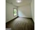 Bedroom with neutral carpet, gray trim, and natural light at 304 N Dogwood Ave, Social Circle, GA 30025