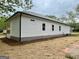 Picture of home's exterior with white siding, black trim, and new landscaping at 304 N Dogwood Ave, Social Circle, GA 30025