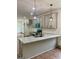 Open kitchen design with granite countertops, tile backsplash and pendant lighting at 304 N Dogwood Ave, Social Circle, GA 30025