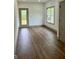 Bright room boasts hardwood floors, natural light from the backyard, and neutral paint at 304 N Dogwood Ave, Social Circle, GA 30025